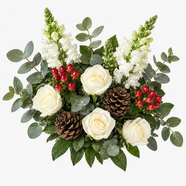 Overhead view of the Dew flowers arranged in a vase, with white roses, snapdragons and pine cones