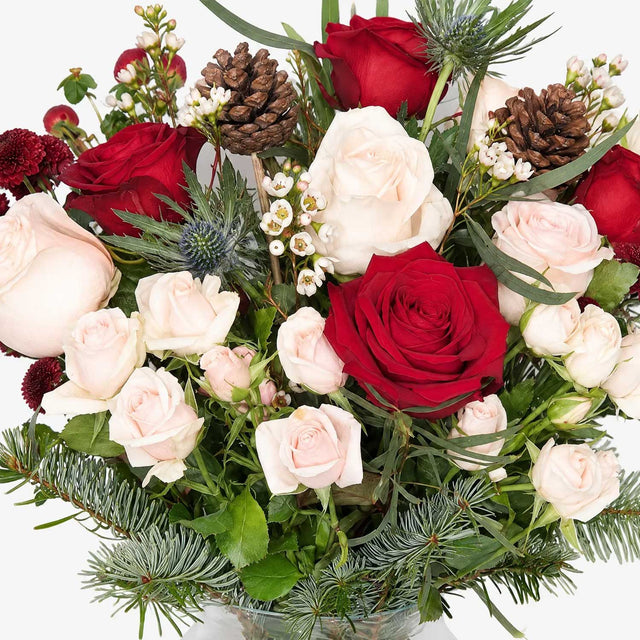 Close-up of red roses and cream spray roses in The Noel Christmas bouquet