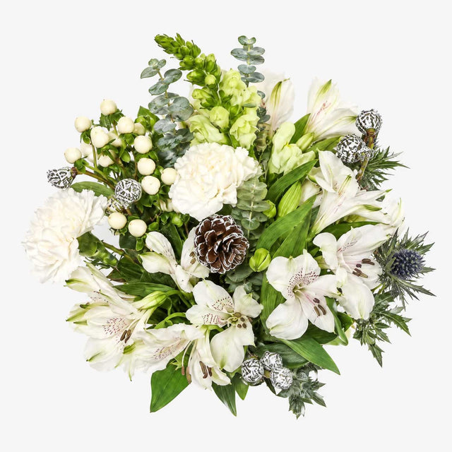 Over head view of white Christmas letterbox flowers with snapdragons, carnations and blue eryngium