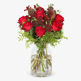 The Crimson red Christmas bouquet in a vase with red roses, skimmia and pine cones