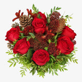 Overhead view of red roses and skimmia in The Crimson Christmas bouquet
