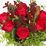 Close-up of red roses and skimmia in The Crimson Christmas bouquet