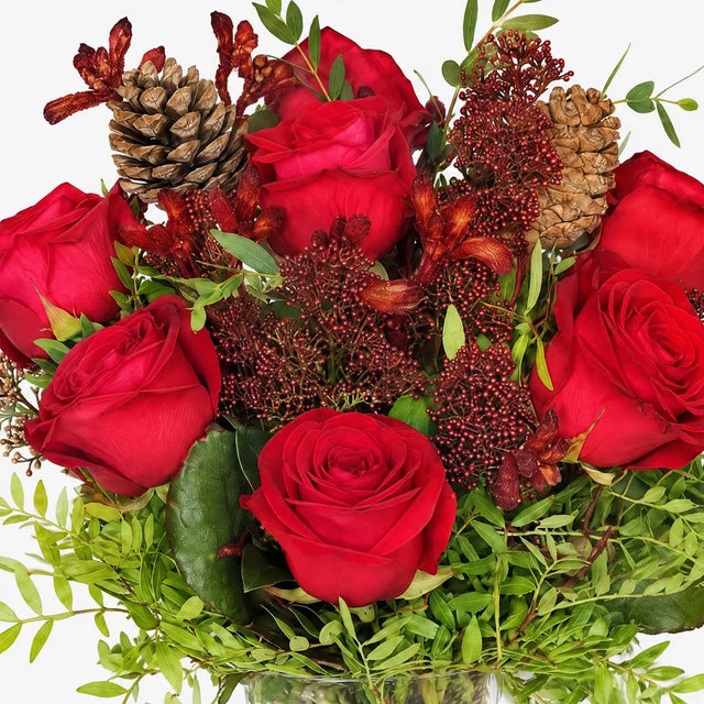 Close-up of red roses and skimmia in The Crimson Christmas bouquet