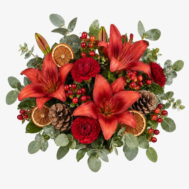 Overhead view of red lilies in The Mulberry hand-tied festive bouquet